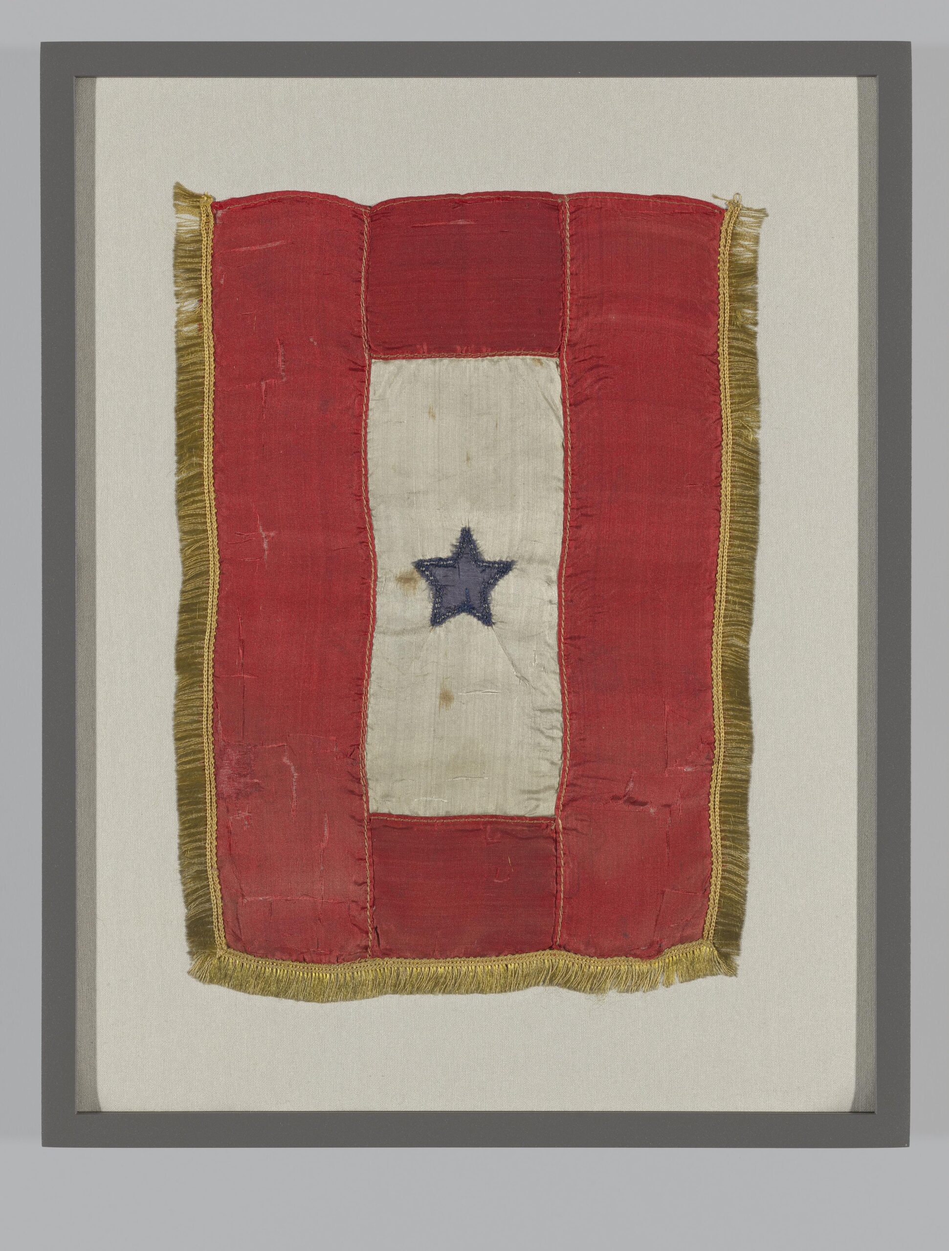 A Blue Star service flag with a white field, red border and a single blue star