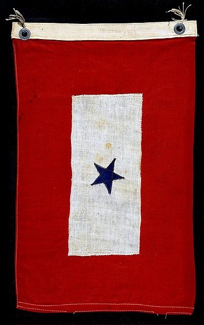 A red Man in Service flag with a white centre panel and one blue star