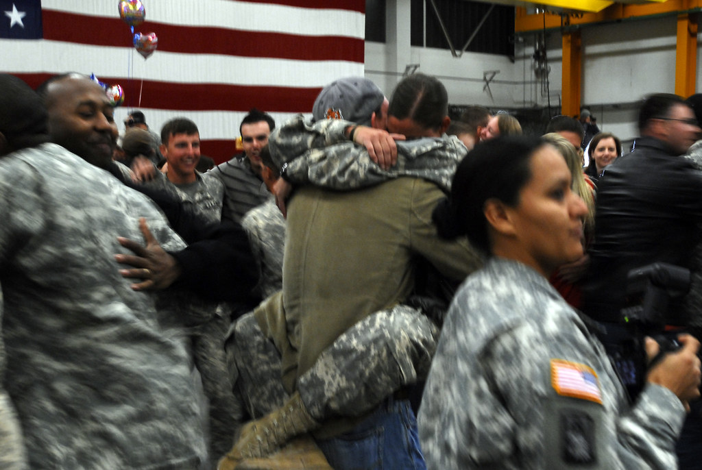 Families waiting and embracing soldiers at a unit homecoming