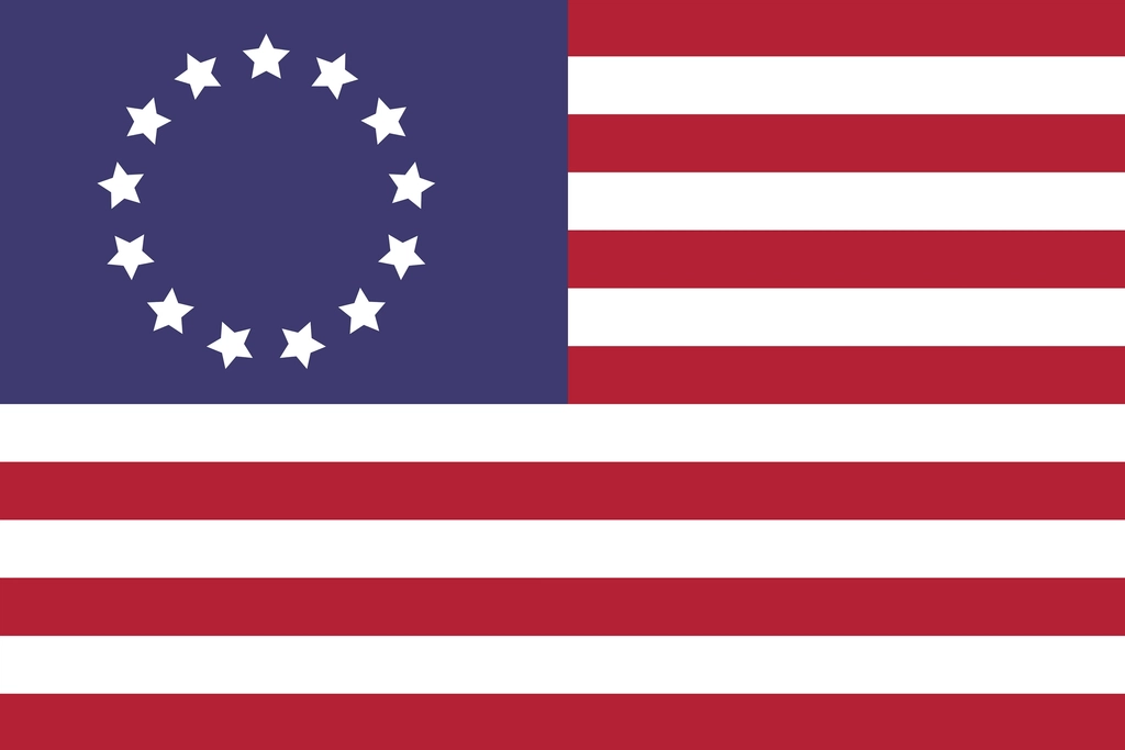 The Betsy Ross flag, thirteen white stars arranged in a circle on a blue field