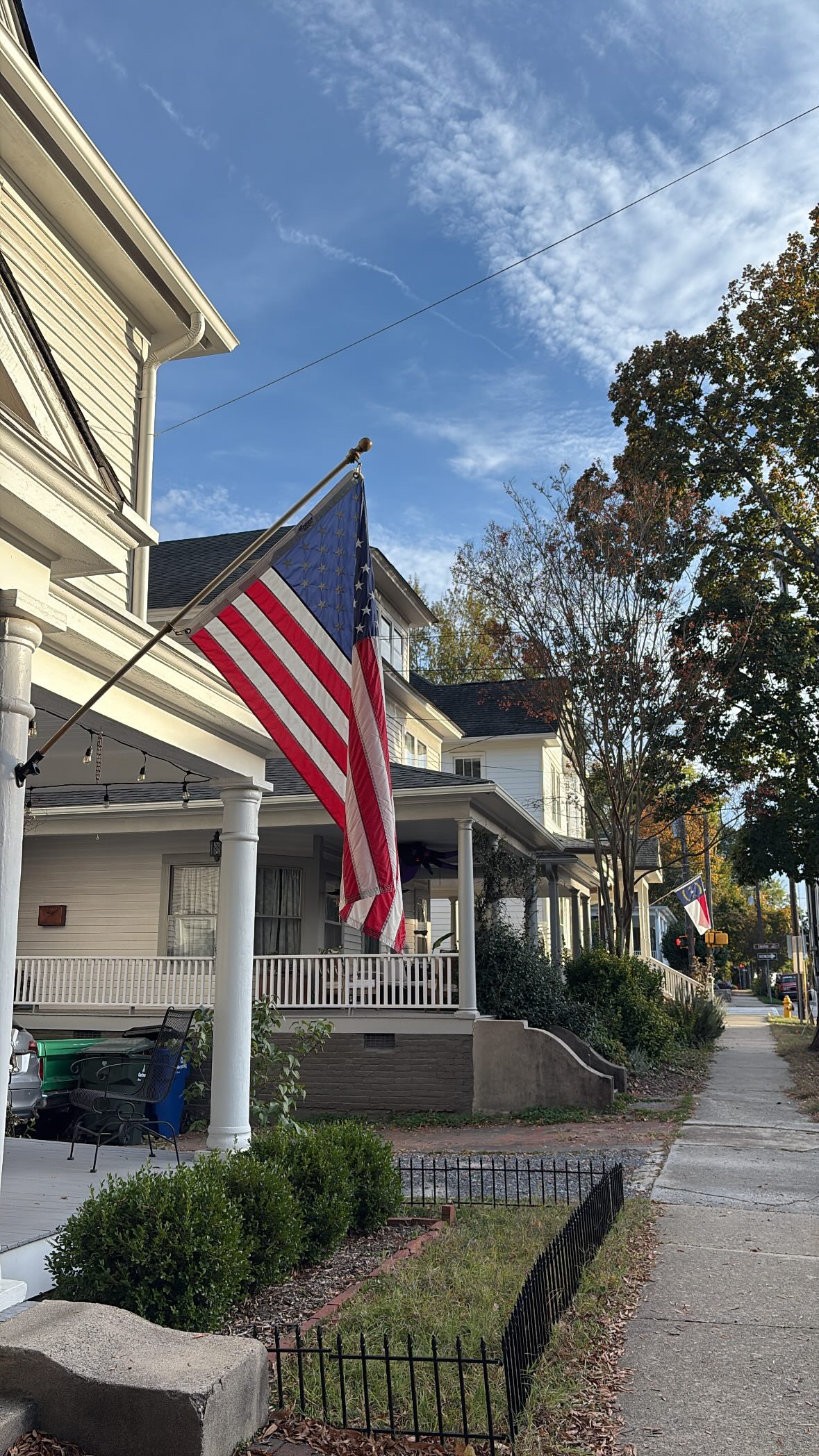 American flag on an angled porch bracket, union at the peak of the staff